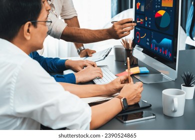Data analysts team working analyzing business intelligence BI dashboard display on laptop to analyze financial, trend, and marketing data. BI technology and data analysis for business success. Prudent