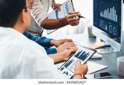 Data analysts team working analyzing business intelligence BI dashboard display on laptop to analyze financial, trend, and marketing data. BI technology and data analysis for business success. Prudent