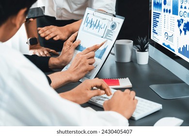 Data analysts team working analyzing business intelligence BI dashboard display on laptop to analyze financial, trend, and marketing data. BI technology and data analysis for business success. Prudent