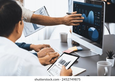 Data analysts team working analyzing business intelligence BI dashboard display on laptop to analyze financial, trend, and marketing data. BI technology and data analysis for business success. Prudent