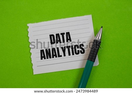 Data analytics message written on ripped paper piece with greenbackground. Conceptual data analytics symbol. Copy space.