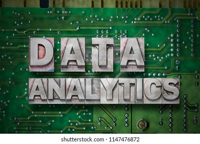 data analytics phrase made from metallic letterpress blocks on the pc board background