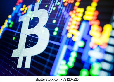 Data analyzing in exchange stock market: the candle chars on display. Analytics price change cryptocurrency BTC to USD (Bitcoin / US Dollar), the most popular pair in the world. Big Bitcoin logo.