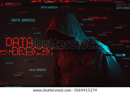Data breach concept with faceless hooded male person, low key red and blue lit image and digital glitch effect