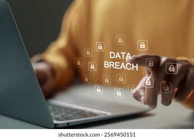 Data breach and hacker attack concept. Person use laptop with Data breach word and padlock icon for information leak. data protection, firewalls, privacy measures, and access information.