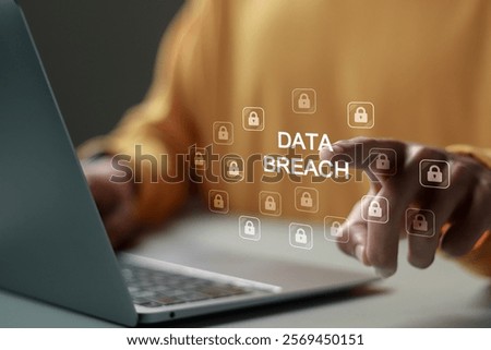 Data breach and hacker attack concept. Person use laptop with Data breach word and padlock icon for information leak. data protection, firewalls, privacy measures, and access information.