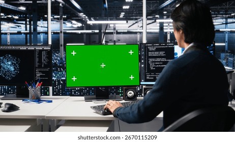 Data center admin typing on isolated screen PC keyboard, using AI. IT specialist at work using artificial intelligence on chroma key computer to oversee servers powering deep learning, camera A