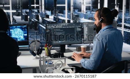 Data center admin using AI assistant to provide user technical support and solutions to users. Server farm IT expert managing live support calls assisted by artificial intelligence chatbot, camera A