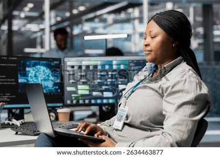 Data center admin using artificial intelligence neural networks node trees on laptop. Server room specialist using using AI programming language on notebook, configuring specialized hardware