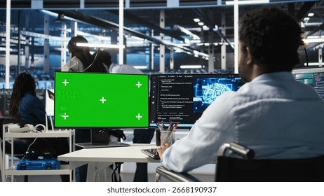 Data center admin in wheelchair using AI node tree software on green screen PC to minimize system downtime. Server hub employee in disability using visual programming tool on mockup computer, camera A