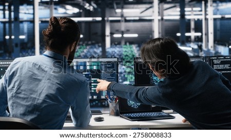 Data center admins doing brainstorming, working on neural network software development. Server farm IT employees working together, implementing machine learning technology using PC, camera A