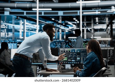 Data center admins programming infrastructure used for machine learning training. Server hub IT professionals collaborating running code on PC to upgrade artificial intelligence systems