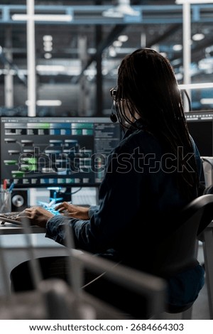 Data center call center agent providing logistics support to businesses, talking in headset mic. Worker in server room establishment overseeing node trees and communicating with engineers