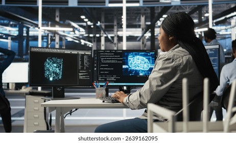 Data center computer scientist using artificial intelligence deep learning models to configure hardware. IT specialist using AI programming languages on PC in server farm, optimizing system, camera A