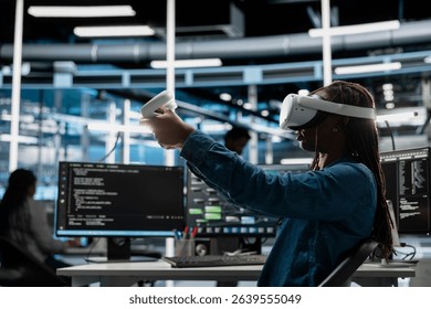 Data center developer uses VR headset and AI technology for machine learning workloads. Server hub specialist using virtual reality and artificial intelligence to perform demanding computing tasks