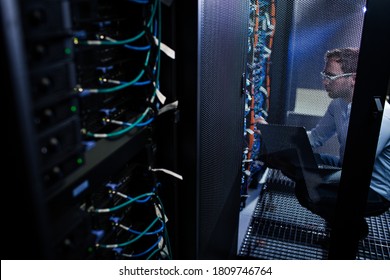 Data Center Employee Running Tests On The Server Computers,  Dealing With An Urgent Issue, Security Breach,  Updateing The System (color Toned Image)