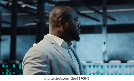 Data center engineer adjusting blade server hardware powering artificial intelligence processing operations. Admin oversees server arrays handling training datasets infrastructure, camera B