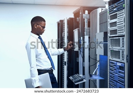 Data center, engineer and black man with pc in server room for information technology, maintenance or software update. Cyber, code and technician for troubleshooting, configuration or system recovery