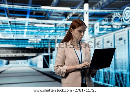 Data center engineer managing infrastructure systems for uptime and efficiency using laptop. Server room IT professional upgrading enterprise networks hardware using notebook