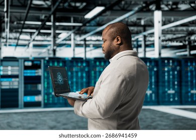 Data center engineer using artificial intelligence automation tools on laptop to increase uptime. Server hub worker working with AI machine learning to accelerate complex AI calculations