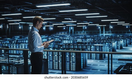 Data Center Engineer Using Digital Tablet Computer, Maintenance Specialist. High-Tech Information Protection, Cyber Security. Cloud Computing Facility. Server Farm For Iaas, Saas, Paas.