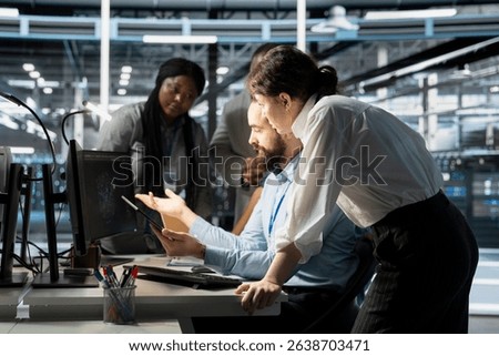 Data center engineering team doing brainstorming, monitoring system performance using computer, identifying bottlenecks. Server farm coworkers troubleshooting errors, implementing optimizations