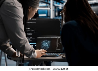 Data center engineering team using AI visualization tool to optimize resource allocation. Server farm teamworking colleagues use artificial intelligence analysis software to do maintenance