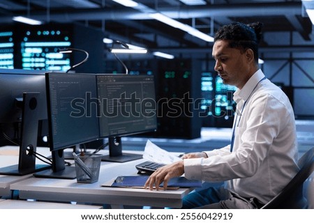 Data center IT expert developing strategies and procedures to ensure business continuity in case of disaster or system failure. Server hub employee ensuring compliance with industry regulations