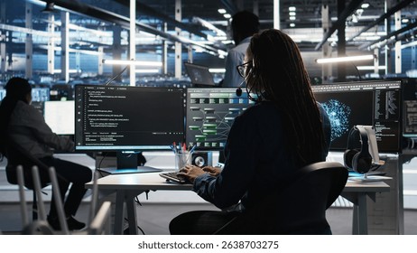 Data center expert examines node tree interface, delivering technical support. Server room technician talking in headset mic with coworkers, using visual programming software, camera A