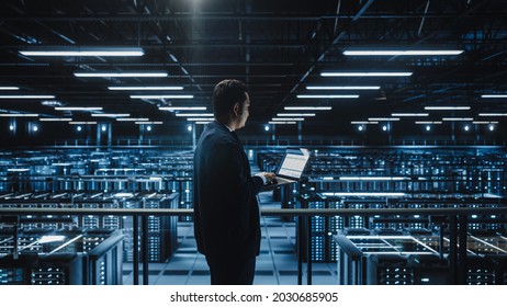 Data Center Male Administrator Using Laptop Computer. Maintenance Specialis working in Cloud Computing Facility on Cyber Security and Network Protection. Server Farm Analytics. Medium Wide - Powered by Shutterstock - Get 15% off with code: PIKWIZARD15