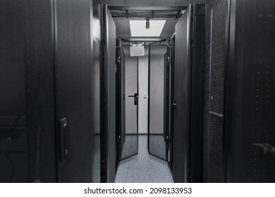 Data Center With Multiple Rows of Fully Operational Server Racks. Modern Telecommunications, Cloud Computing, Artificial Intelligence, Database, Supercomputer Technology Concept.