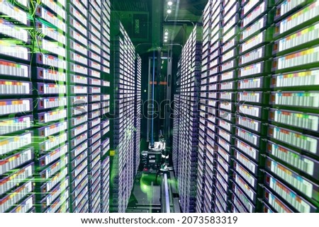 Data center with multiple rows of fully operational server racks. modern cloud computing technology concept.