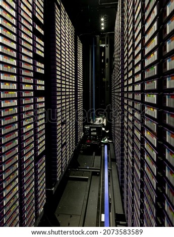 Data center with multiple rows of fully operational server racks. modern cloud computing technology concept.
