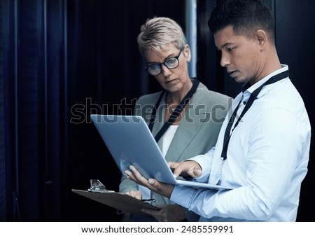 Data center, people and computer engineer with clipboard, collaboration and programming. Mature woman, analytics and technician with hardware, security or maintenance for system update in server room