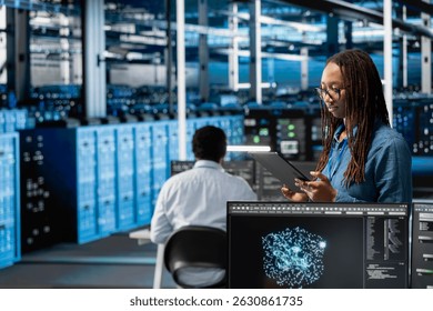 Data center programmer uses AI visualization tool on tablet to optimize resource allocation. Server hub IT professional uses artificial intelligence analysis on device to do maintenance