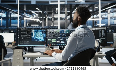 Data center programmer uses machine learning node tree program to identify equipment issues. Server hub worker reviewing artificial intelligence data analysis graph to minimize failures, camera A