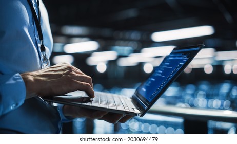 Data Center Programmer Using Digital Laptop Computer, Maintenance IT Specialist. Cloud Computing Server Farm System Administrator Working on Cyber Security for Iaas, saas, paas. Closeup Focus on Hands