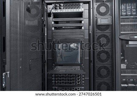 Data center server rack with rackmount KVM console and network equipment in a modern IT room