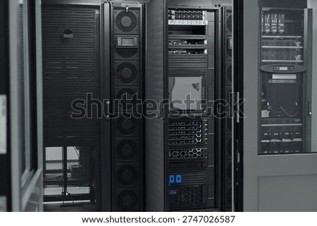 Data center server racks and network equipment in a modern IT infrastructure room with cooling systems