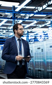 Data center software developer using tablet to monitor supercomputers metrics. Server farm IT expert using device application to enhance operational effectiveness of IT infrastructure