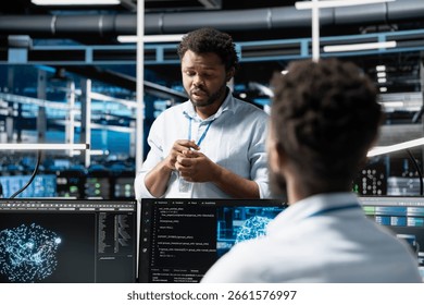 Data center software developers using machine learning algorithms to analyze large datasets. Server farm workplace colleagues cooperating, using artificial intelligence to recognize data patterns