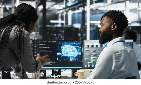 Data center supervisor overseeing work done by engineer using deep learning algorithms to analyze datasets. Server room team leader worker supervising using AI tech to recognize data patterns
