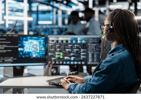 Data center support expert talking in headset microphone, supporting engineering team doing equipment maintenance. Employee in server farm coordinating technicians using mic