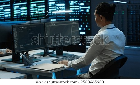 Data center system administrator responsible for installation of networking equipment solving tasks. IT employee at work doing maintenance on server room hardware, camera A