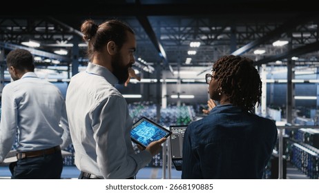 Data center system administrators performing maintenance on supercomputers used for AI. Engineering team managing server hub rigs used for deep learning training,