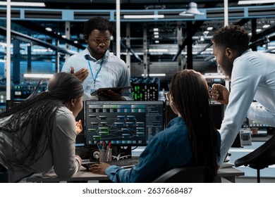 Data center system administrators using PC to visualize artificial intelligence neural networks made up of interconnected nodes. Server farm coworkers doing brainstorming, overseeing AI systems