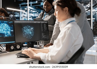 Data center team of programmers using artificial intelligence neural networks technology. Server farm coworkers using AI programming language on computer to update equipment - Powered by Shutterstock - Get 15% off with code: PIKWIZARD15