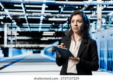 Data center tech support expert communicating through headset microphone, doing incident resolution. Server farm engineer troubleshooting network issues for clients, ensuring uptime