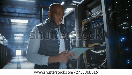 Data center technician inspects server racks, checks network cables, and uses a tablet to monitor hardware status. Rows of illuminated servers, digital infrastructure, and secure network operations.