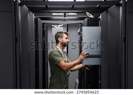 Data center technician installing and maintaining servers in a modern server rack